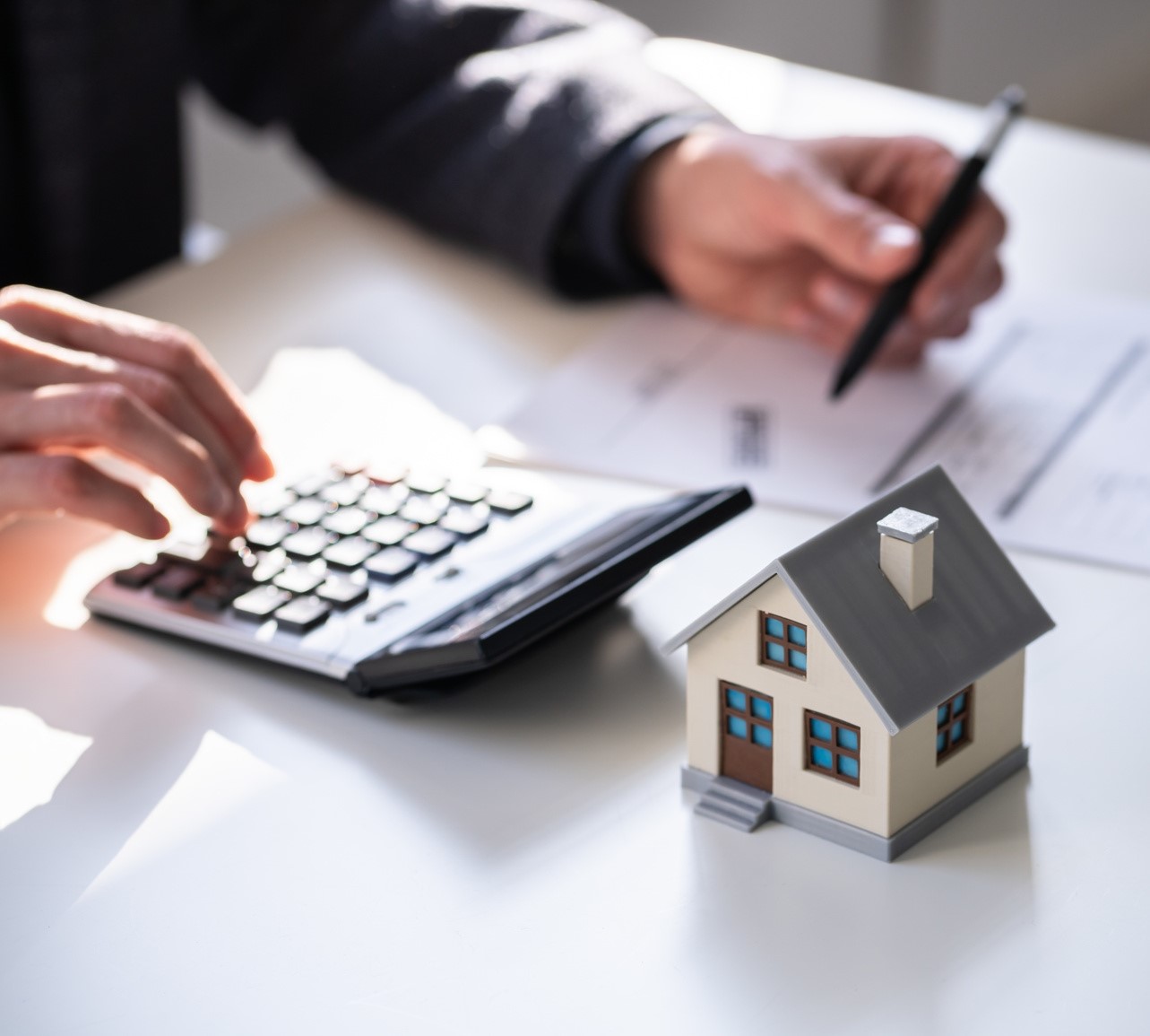 Man working on documents calculation something on a calculator 